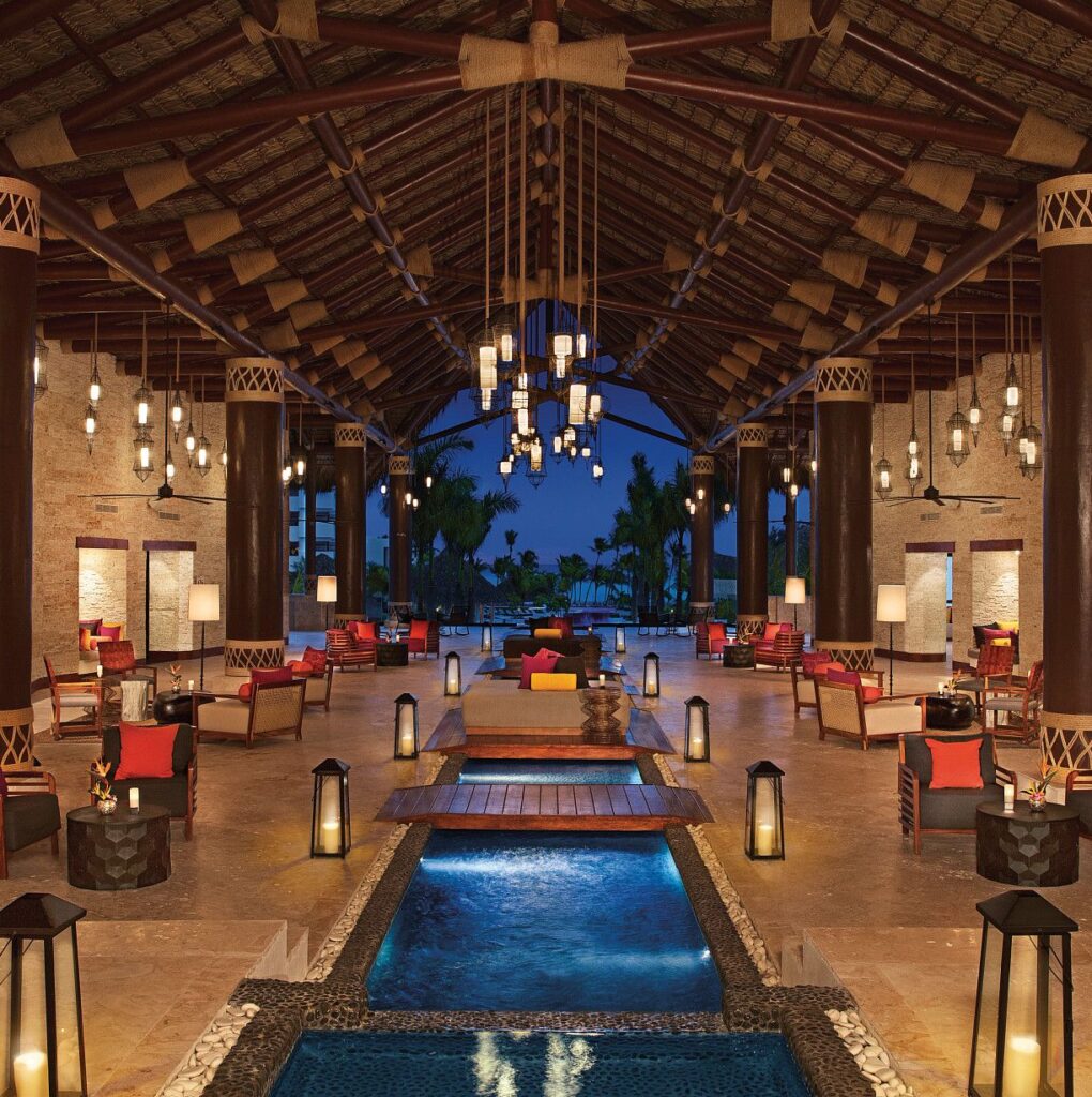 Tropical resort hotel lobby with central water feature